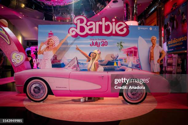 Barbie" fan poses for photos in a carboard car during the "Barbie" movie premiere in Bangkok, Thailand on July 19, 2023. People attend the pink...