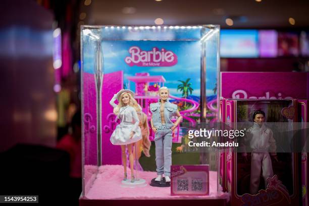 Barbie" dolls are seen in a glass case at the "Barbie" movie premiere in Bangkok, Thailand on July 19, 2023. People attend the pink carpet world...