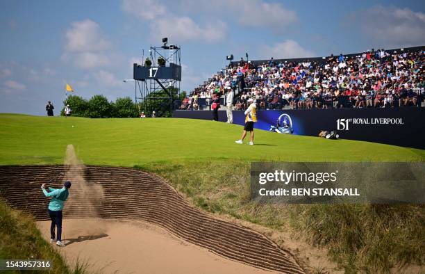 Ireland's Alex Maguire plays out of a bunker onto the 17th green on day one of the 151st British Open Golf Championship at Royal Liverpool Golf...