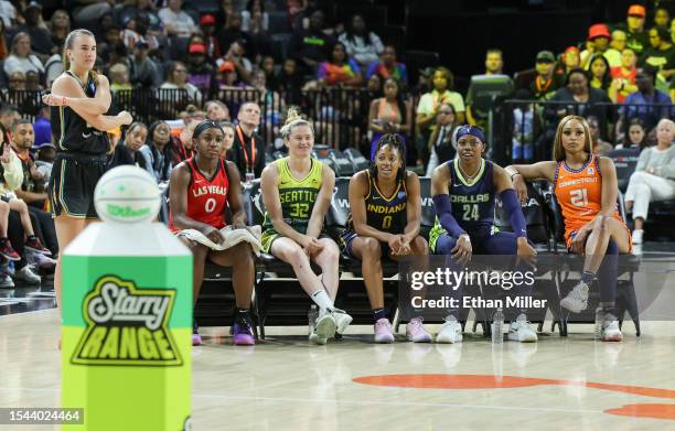 Sabrina Ionescu of the New York Liberty gets ready to compete in the first round of the WNBA 3-Point Contest as other contestants Jackie Young of the...