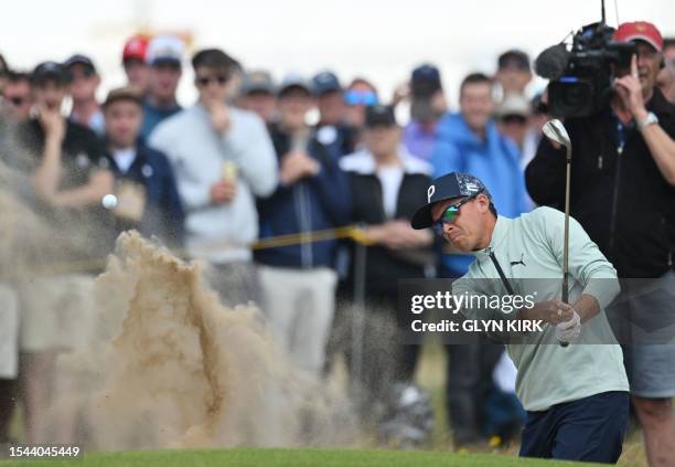 Golfer Rickie Fowler plays from a bunker onto the 8th green on day one of the 151st British Open Golf Championship at Royal Liverpool Golf Course in...