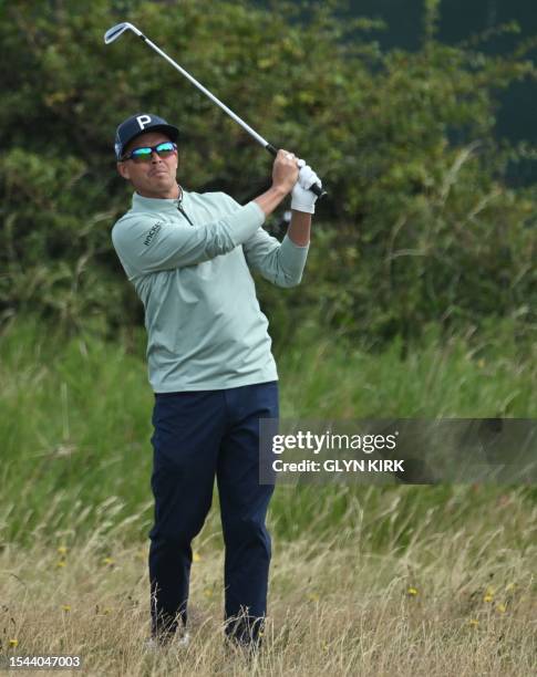 Golfer Rickie Fowler plays from the rough on the 8th fairway on day one of the 151st British Open Golf Championship at Royal Liverpool Golf Course in...