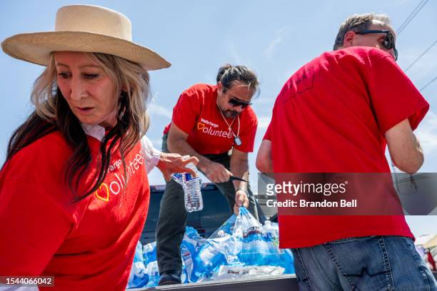 Volunteers with the Wells Fargo Technology Services organize water bottles in preparation to pass them out to homeless residents on July 14, 2023 in...
