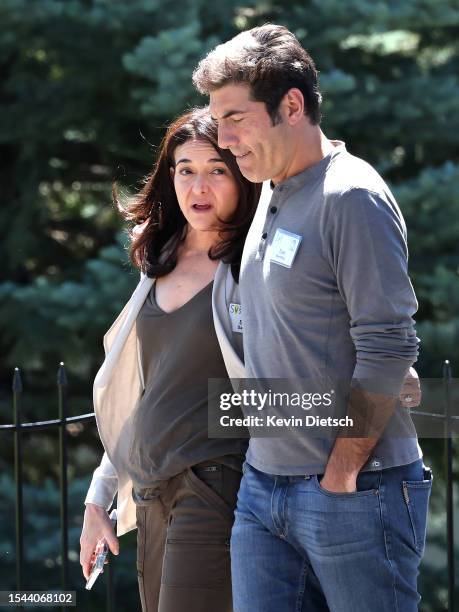 Sheryl Sandberg, former COO of Meta Platforms, and her husband Tom Bernthal walk to a morning session at the Allen & Company Sun Valley Conference on...