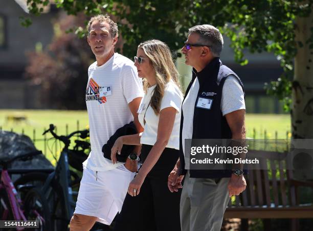 Jesse Itzler , co-founder of Marquis Jet, Sara Blakely, and Paul Salem, walk together at the Allen & Company Sun Valley Conference on July 14, 2023...