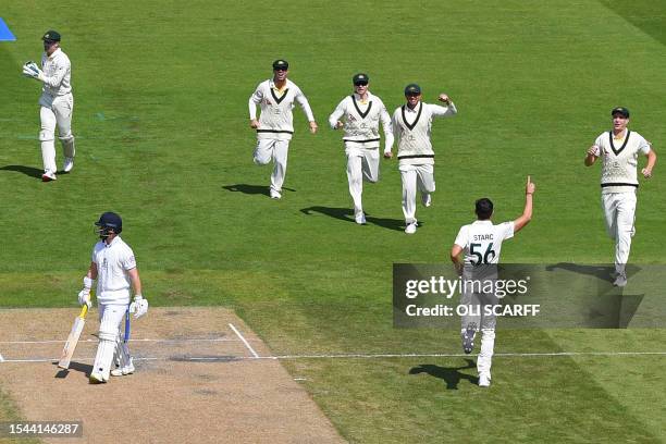 Australia's Mitchell Starc celebrates with teammates after taking the wicket of England's Ben Duckett , caught by Australia's wicket keeper Alex...