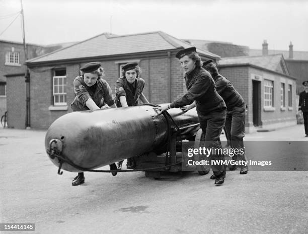 Women On The Home Front 1939 - 1945, The Women's Royal Naval Service : A torpedo being moved by a group of four Wrens so that it could be loaded into...