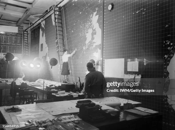 The Royal Navy During The Second World War, In the operations room at Derby House, Liverpool, where up to the minute shipping positions are shown on...