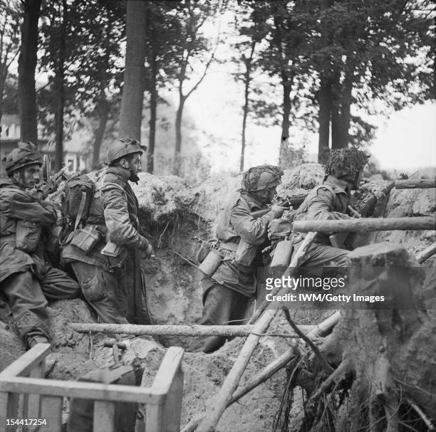 The British Airborne Division At Arnhem And Oosterbeek In Holland, Men of the 1st Paratroop Battalion take cover in a shell hole, 17 September 1944.