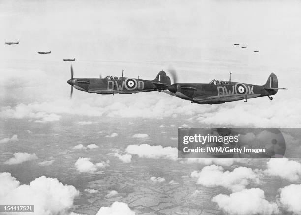 Supermarine Spitfire Mark IAs, , of No 610 Squadron, Royal Air Force based at Biggin Hill, Kent, flying in three 'vic' formations, during the Battle...