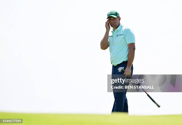 Ireland's Padraig Harrington putts on the 17th green on day one of the 151st British Open Golf Championship at Royal Liverpool Golf Course in...