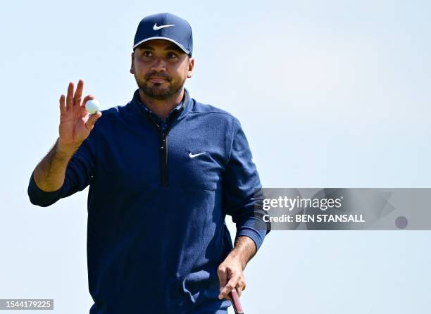 Australia's Jason Day putts on the 17th green on day one of the 151st British Open Golf Championship at Royal Liverpool Golf Course in Hoylake, north...