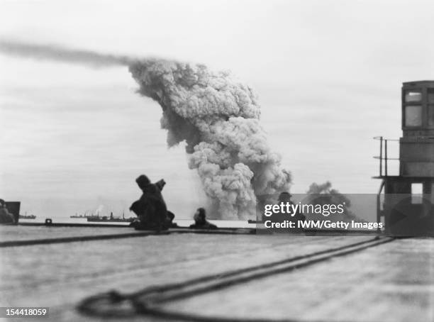 The Royal Navy During The Second World War, Seen from the deck of an aircraft carrier , a merchant ship is bombed in the convoy PQ 18, 13 September...