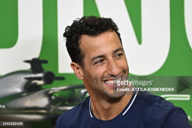 Alpha Tauri's Australian driver Daniel Ricciardo smiles during a press conference in Mogyorod near Budapest on July 20 ahead of the Formula One...