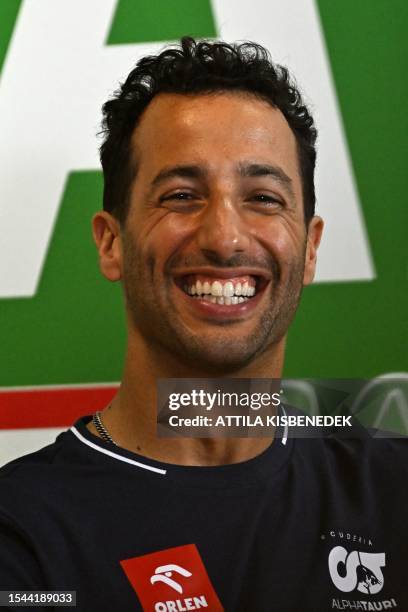 Alpha Tauri's Australian driver Daniel Ricciardo smiles during a press conference in Mogyorod near Budapest on July 20 ahead of the Formula One...