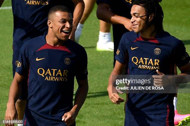 Paris Saint-Germain's French forward Kylian Mbappe and his younger brother Paris Saint-Germain's French Midfielder Ethan Mbappe react as they take...