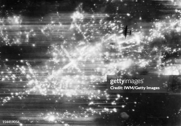 Royal Air Force Bomber Command, 1942-1945, Vertical photograph taken from 19,000 feet during a night raid on Hannover, showing an Avro Lancaster,...