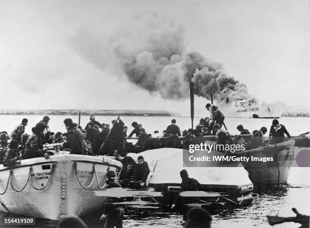 The Falklands Conflict, April - June 1982, Lifeboats carrying crew and soldiers of 1st Battalion Welsh Guards reach shore at Fitzroy, having escaped...