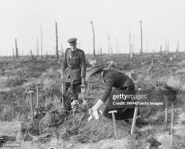 South African Forces On The Western Front, A South African nurse places a wreath on her brother's grave at Delville Wood, 17 February 1918. Here,...