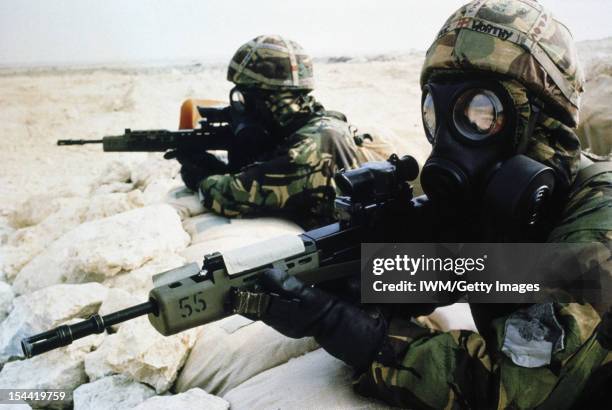 The Gulf War 1990 - 1991, Two British soldiers in NBC [Nuclear Biological and Chemical] equipment, pose with their SA80 rifles during a training...