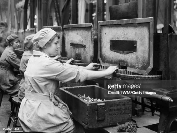 Women At Work During The First World War, Women war workers operate annealing machines in Cartridge Factory 5, at the Royal Arsenal Woolwich, London,...