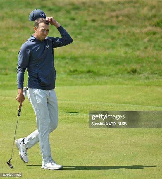 Golfer Jordan Spieth completes his round on the 18th green on day one of the 151st British Open Golf Championship at Royal Liverpool Golf Course in...