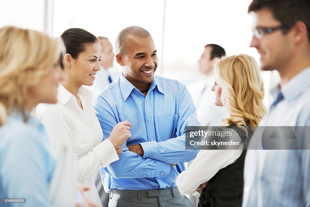 Laughing  businesspeople talking in the office.