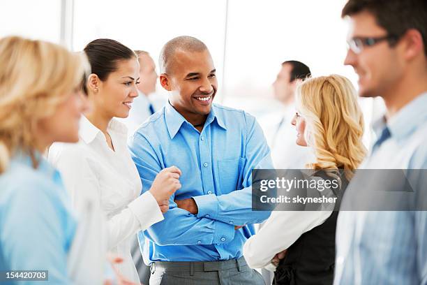 laughing  businesspeople talking in the office. - business networking event stock pictures, royalty-free photos & images