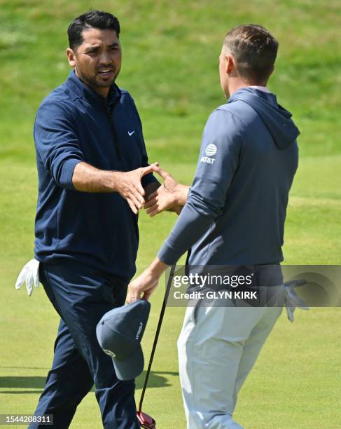 Australia's Jason Day and US golfer Jordan Spieth complete their round on day one of the 151st British Open Golf Championship at Royal Liverpool Golf...