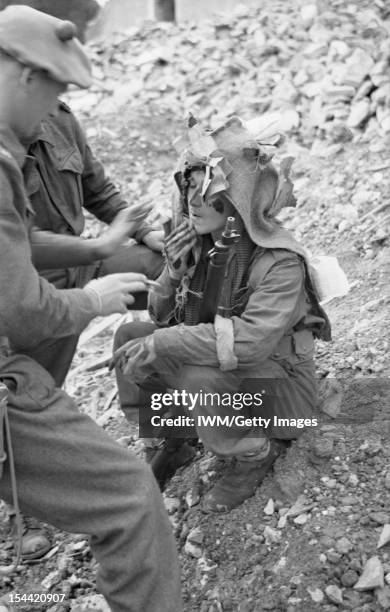 The British Army In Normandy 1944, A sniper applying camouflage face cream at a sniper school in a Normandy village, 27 July 1944.