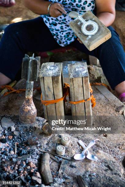 the art of melting bomb metals into jewelry. - plain of jars stock pictures, royalty-free photos & images