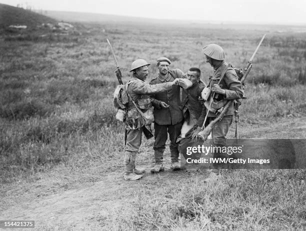 Ministry Of Information First World War Official Collection, Battle of Albert 1 - 13 July: British infantrymen give a helping hand to wounded German...