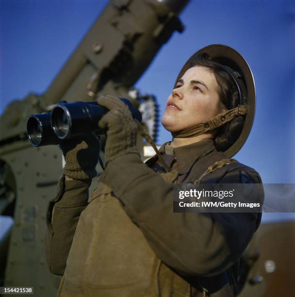 The Auxiliary Territorial Service At An Anti-Aircraft Gun Site In Britain, December 1942, An ATS spotter with binoculars at the anti-aircraft command...