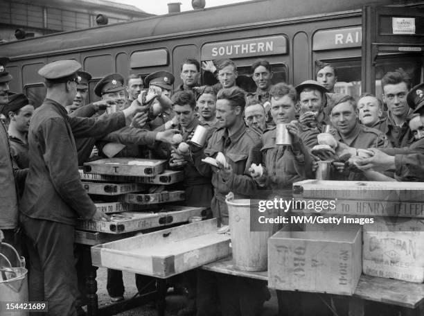 The British Army In The UK: Evacuation From Dunkirk, May - June 1940, Evacuated troops enjoying tea and other refreshments at Addison Road station,...