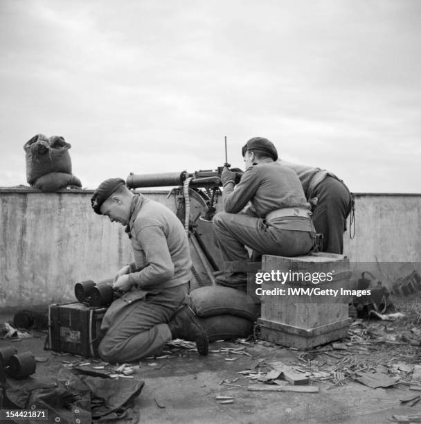 The British Army In Greece 1944, Paratroops from 5th Parachute Battalion, 2nd Parachute Brigade, fire a Vickers machine gun from a rooftop in Athens...