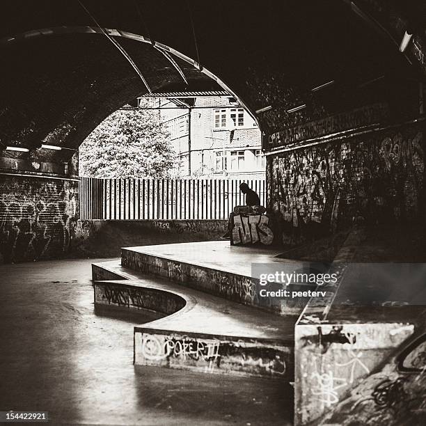 skater sitting alone at skatepark. - london graffiti stock pictures, royalty-free photos & images