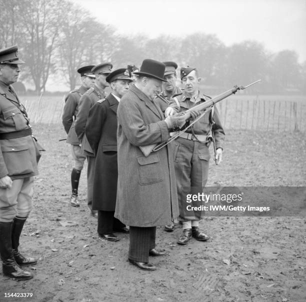 The British Army In The United Kingdom 1939-45, Winston Churchill inspects the new Lee-Enfield No. 4 rifle with spike bayonet during a visit to 53rd...