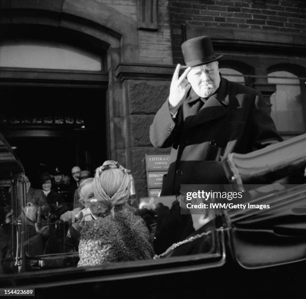 Winston Churchill As Prime Minister 1940-45, Churchill, cigar in mouth, gives his famous 'V' for victory sign during a visit to Bradford, 4 December...