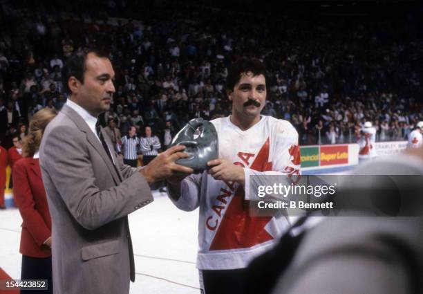 Bryan Trottier of Canada recieves the Labatt Trophy from Sidney M. Holland for the player of the game during the 1981 Canada Cup Finals game against...