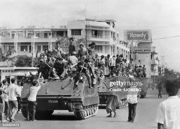 The young Khmer Rouge guerrilla soldiers atop their US-made armored vehicles enter 17 April 1975 Phnom Penh, the day Cambodia fell under the control...