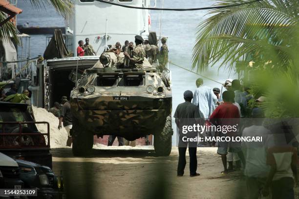 Tanzanian soldiers supervise the arrival of an APC from a military cargo in Stone Town, Zanzibar, 27 October 2005 . A decade of rivalry between the...