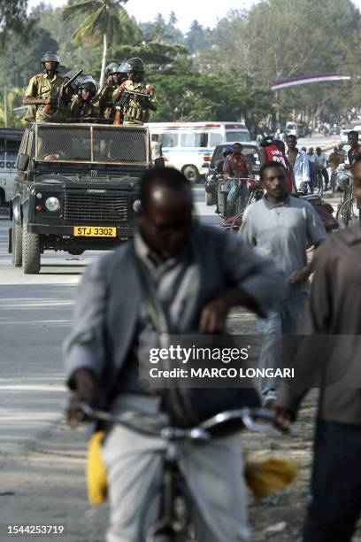 Tanzanian Field Force unit patrol the street on the outskirts of Stone Town, Zanzibar , 27 October 2005 where a CUF rally is taking place. A scuffle...