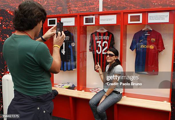 Fan poses next to an exhibition of football memorabilia during the UEFA Champions League Trophy Tour 2012/13 on October 19, 2012 in Rome, Italy.