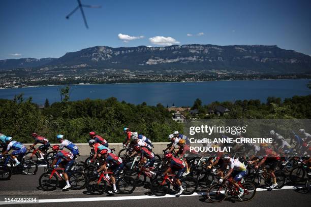 The pack of riders cycles along the Lac du Bourget during the 18th stage of the 110th edition of the Tour de France cycling race, 184 km between...
