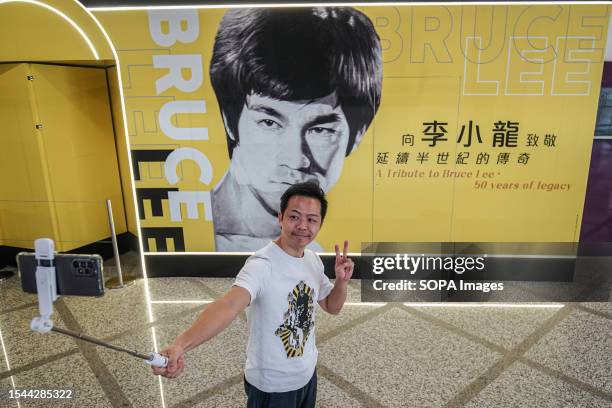 Man selfies in front of a huge poster of Bruce Lee at the Hong Kong Heritage Museum. The Hong Kong government commemorates the 50th anniversary of...