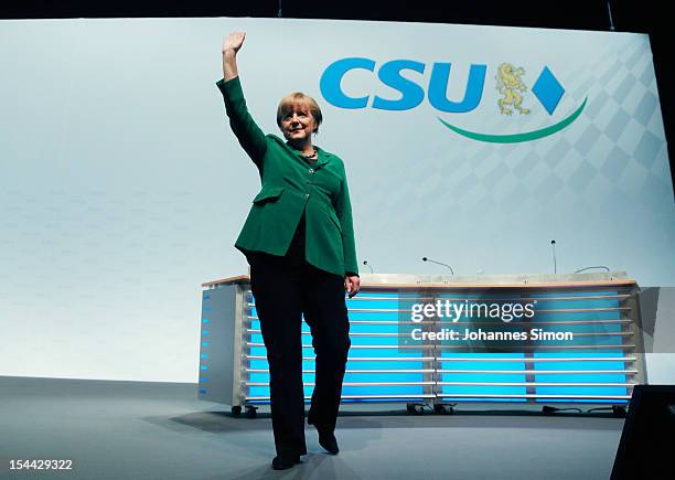 German Chancellor Angela Merkel, who is also chairwoman of the Christian Democratic Union , waves to the audience after delivering a speech at the...