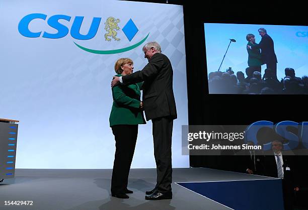 Horst Seehofer , Minister-President of Bavaria and chairman of the Christian Social Union of Bavaria , hugs German Chancellor Angela Merkel, who is...