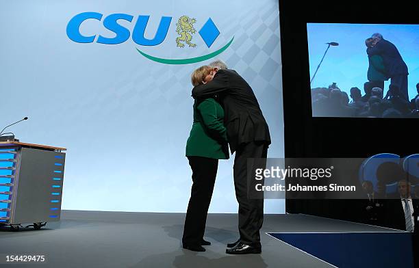 Horst Seehofer , Minister-President of Bavaria and chairman of the Christian Social Union of Bavaria , hugs German Chancellor Angela Merkel, who is...