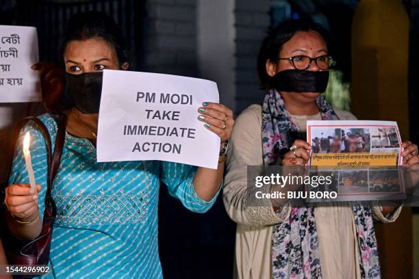 Members of the Satra Mukti Sangram Samiti hold placards during a protest over sexual violence against women and for peace in the ongoing ethnic...