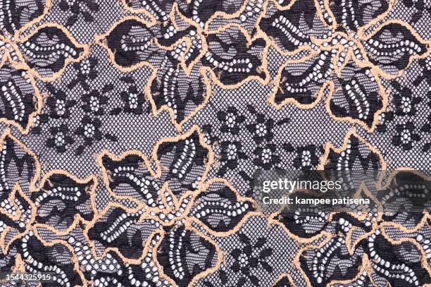 seductive elegance: black lace fabric with intricate gold flower pattern - inspiring artistry - lace textile stock pictures, royalty-free photos & images